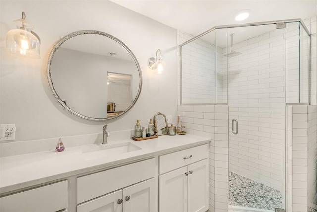 bathroom featuring vanity and a shower with shower door