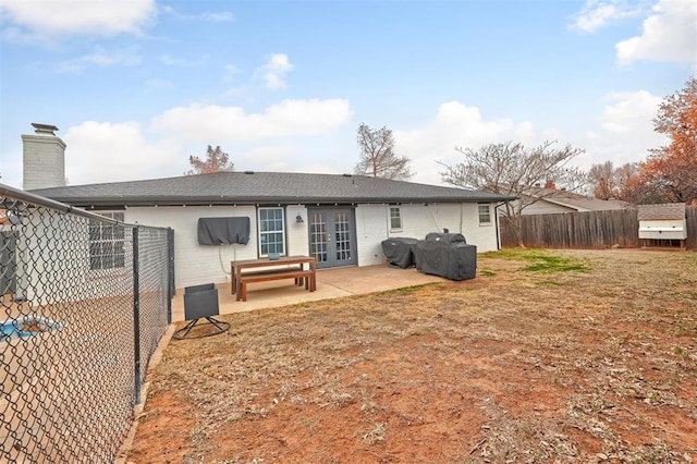 back of house featuring a patio and a lawn