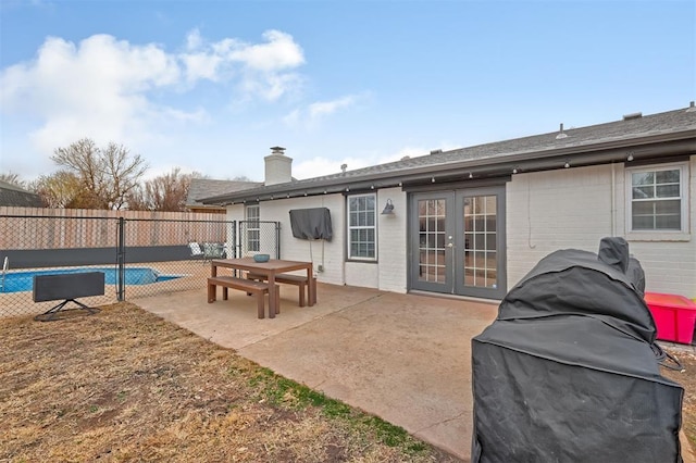 rear view of property featuring a patio area and french doors