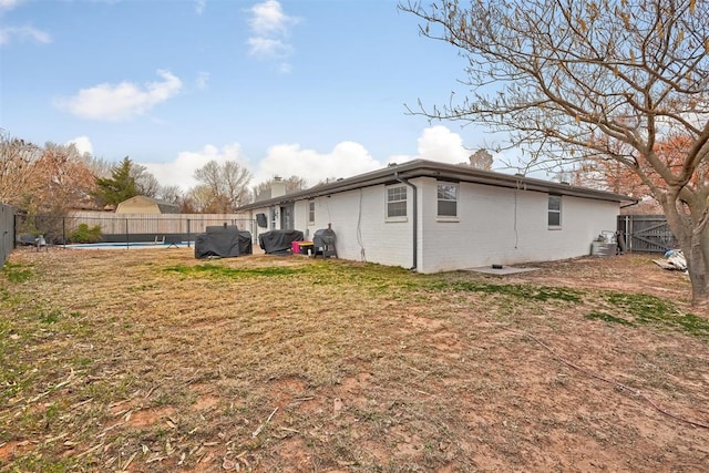 view of home's exterior featuring cooling unit, a fenced in pool, and a yard