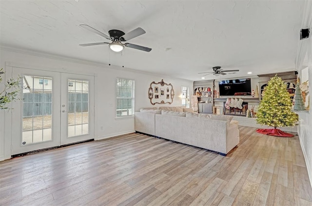 living room featuring ceiling fan, french doors, and light wood-type flooring