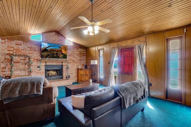 living room with ceiling fan, a brick fireplace, brick wall, lofted ceiling, and wooden walls