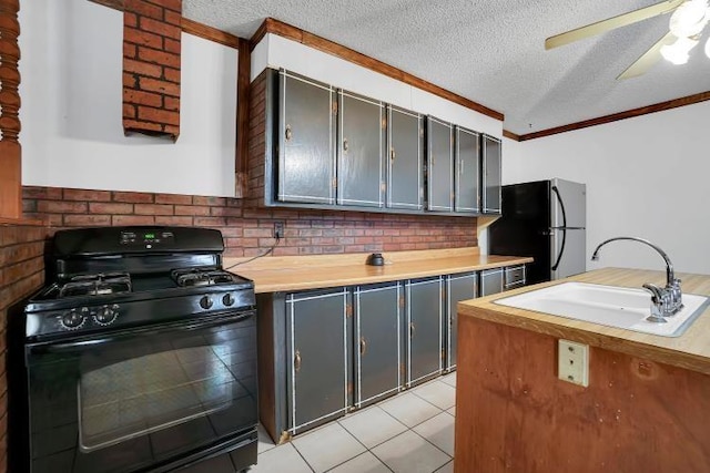 kitchen with black appliances, sink, ceiling fan, light tile patterned floors, and a textured ceiling