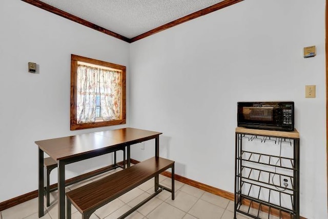 dining room with a textured ceiling and ornamental molding