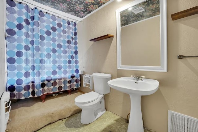 bathroom with a shower, toilet, and sink