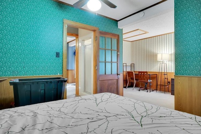 bedroom featuring ceiling fan and wood walls