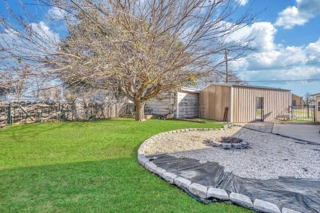 view of yard with a fire pit and an outdoor structure