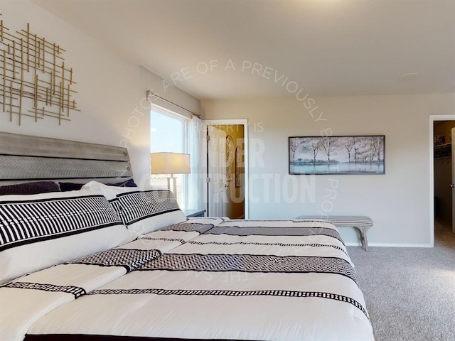 carpeted bedroom with a walk in closet