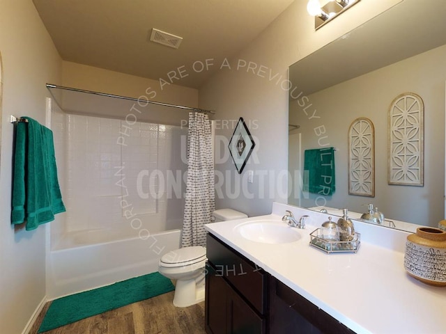 full bathroom featuring hardwood / wood-style flooring, vanity, toilet, and shower / bathtub combination with curtain