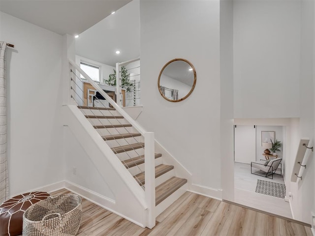 staircase with hardwood / wood-style floors