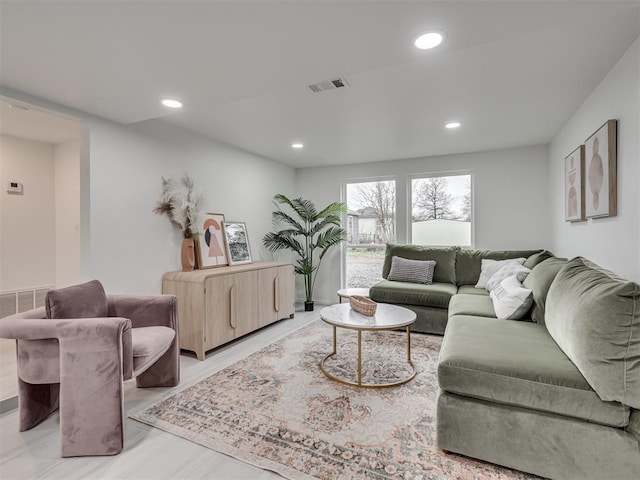 living area with visible vents and recessed lighting