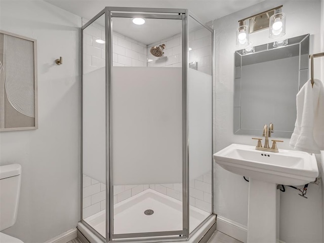 bathroom featuring a shower stall and toilet