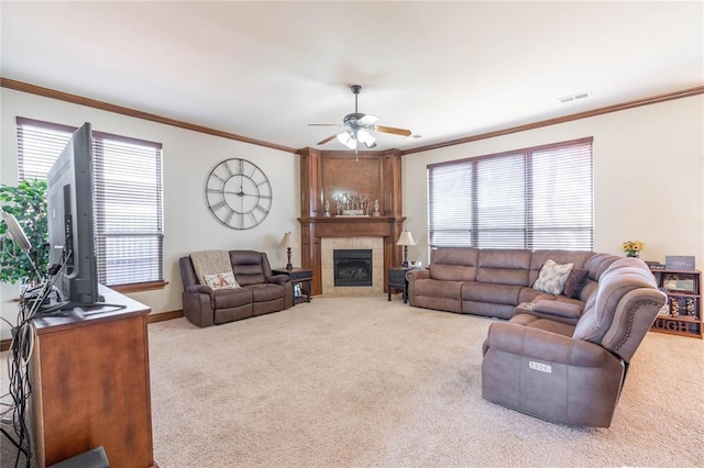 living room featuring light carpet, ceiling fan, and a healthy amount of sunlight