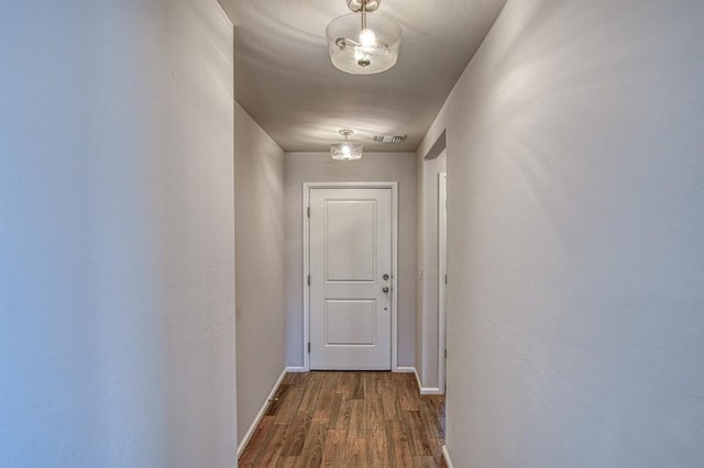 hall with hardwood / wood-style flooring