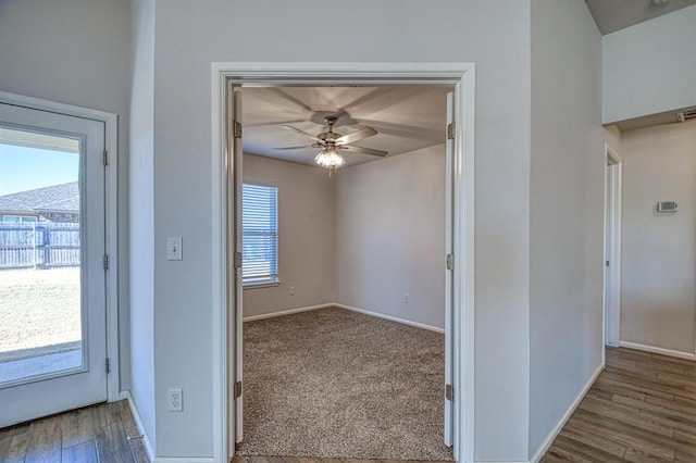 interior space with ceiling fan and wood-type flooring