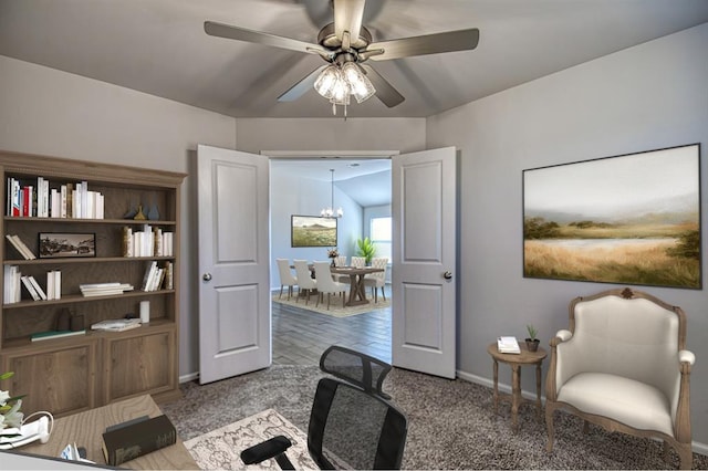 carpeted office with vaulted ceiling and ceiling fan with notable chandelier