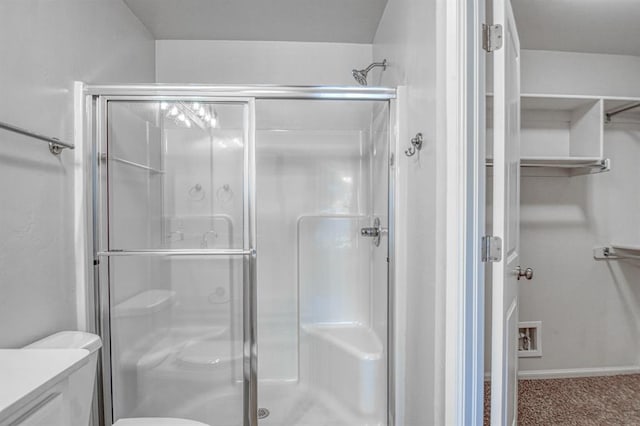 bathroom with vanity and a shower with door