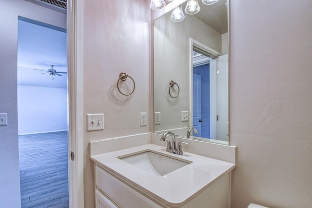 bathroom with vanity, hardwood / wood-style flooring, and ceiling fan