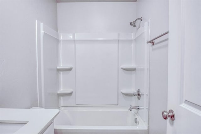 bathroom featuring washtub / shower combination and vanity