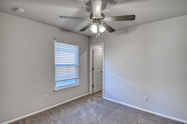 carpeted spare room with ceiling fan