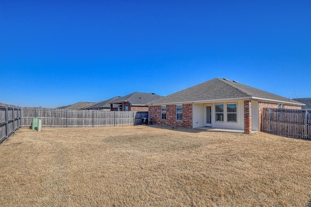 rear view of property featuring a yard