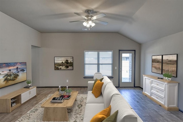 living room featuring lofted ceiling, light wood finished floors, and a ceiling fan