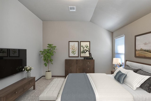 bedroom with vaulted ceiling, baseboards, visible vents, and light colored carpet