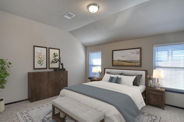 bedroom featuring vaulted ceiling, baseboards, visible vents, and light colored carpet