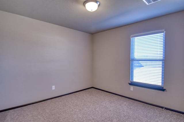 unfurnished room with visible vents and light colored carpet