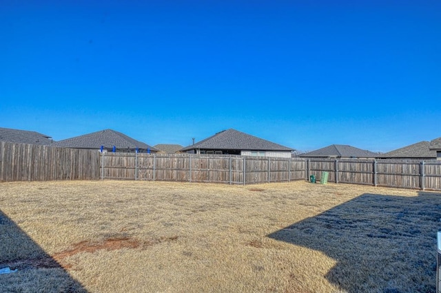 view of yard with a fenced backyard