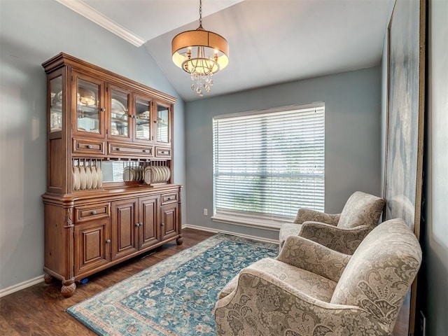 living area with dark wood-type flooring, ornamental molding, lofted ceiling, and a chandelier