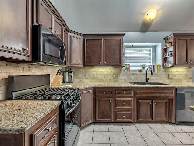 kitchen with sink, light tile patterned floors, backsplash, black appliances, and light stone countertops