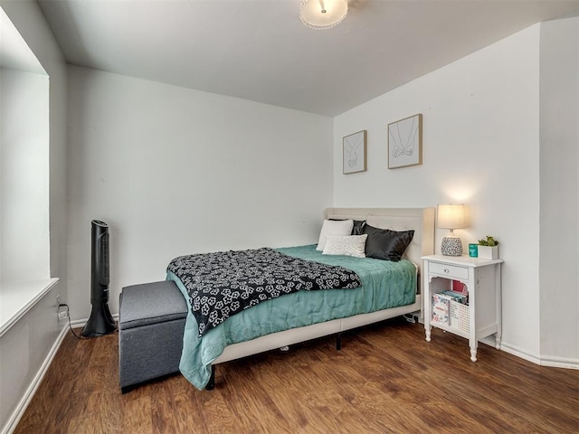 bedroom with dark wood-type flooring