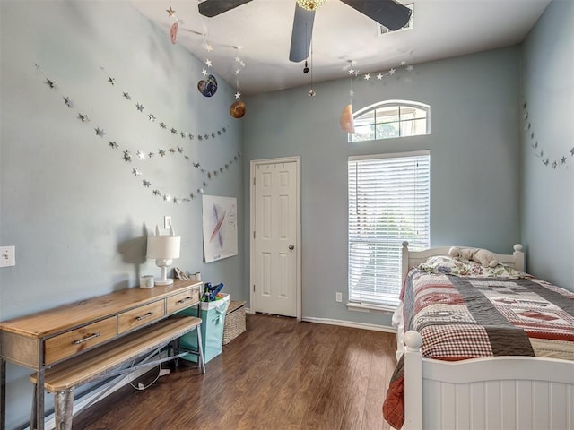 bedroom featuring multiple windows, dark hardwood / wood-style flooring, high vaulted ceiling, and ceiling fan