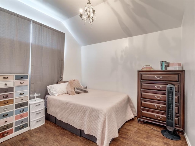 bedroom with lofted ceiling, a chandelier, and wood-type flooring