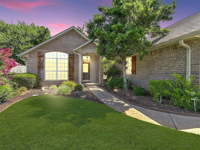 view of front of property with a yard