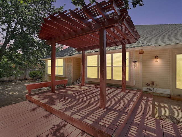 deck at dusk featuring a pergola