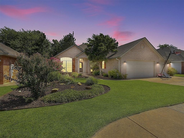 view of front of house featuring a garage and a lawn