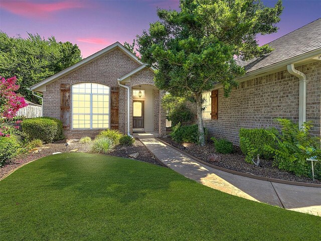 1801 Del Simmons Dr, Edmond, OK 73003 - view of front of house with brick siding and a front yard