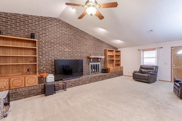 living room with lofted ceiling, ceiling fan, a textured ceiling, a fireplace, and light colored carpet