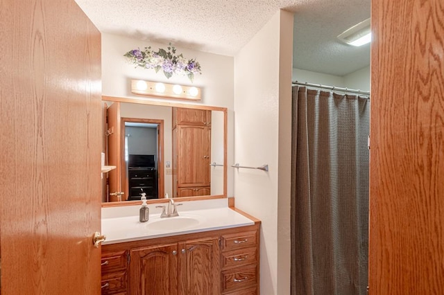 bathroom featuring vanity and a textured ceiling