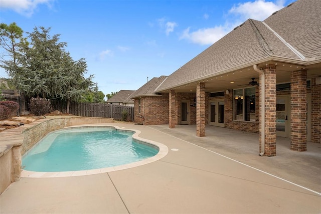 view of pool with a patio, ceiling fan, and french doors