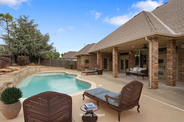 view of swimming pool featuring ceiling fan, outdoor lounge area, and a patio