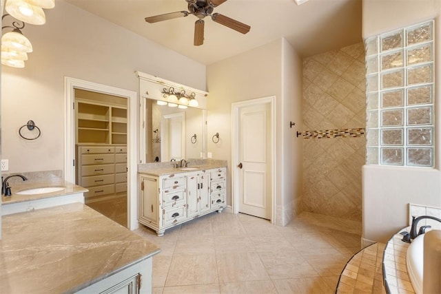 bathroom with ceiling fan, tile patterned floors, shower with separate bathtub, and vanity