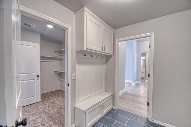 mudroom featuring dark tile patterned flooring