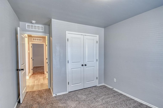 unfurnished bedroom with carpet and a closet