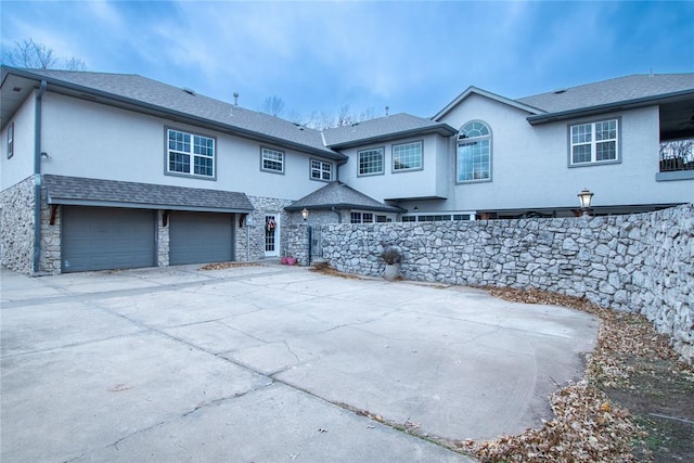 back of property with a garage