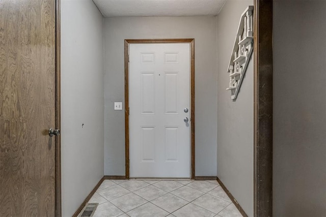 doorway to outside featuring light tile patterned floors