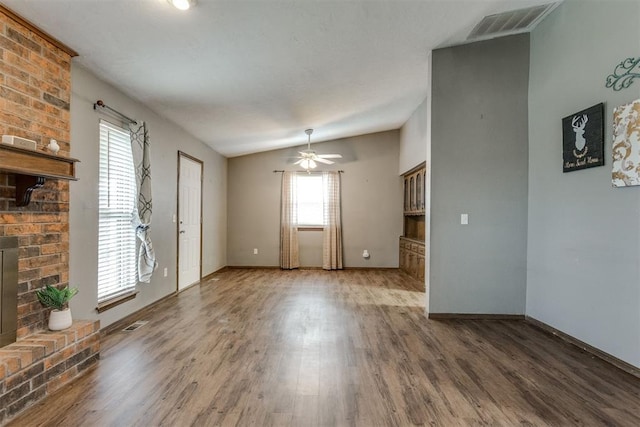 unfurnished living room featuring ceiling fan, a fireplace, lofted ceiling, and hardwood / wood-style flooring