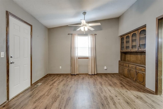 unfurnished dining area featuring light wood-type flooring and ceiling fan